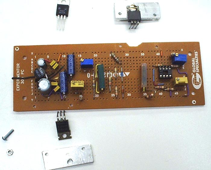 Photo of nearly finished board with heatsinks next to it.